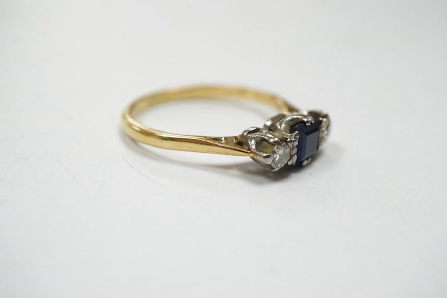 A yellow metal, sapphire and diamond set three stone ring, size Q, gross weight 3 grams. Condition - fair